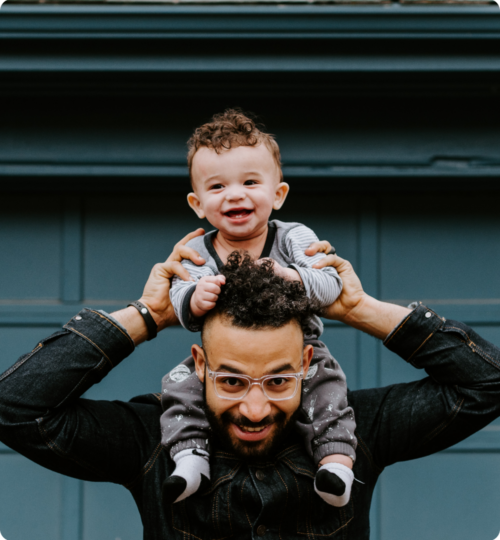 father with son on his shoulders