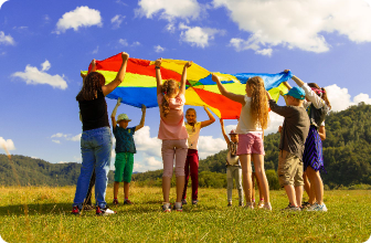children playing with parachute in field