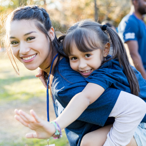 Volunteer for Kansas Children's Service League Woman and little girl smiling