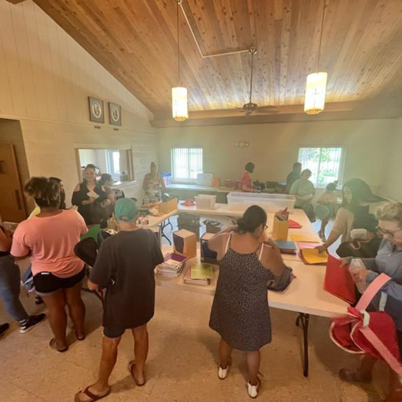 volunteers filling head start backpacks