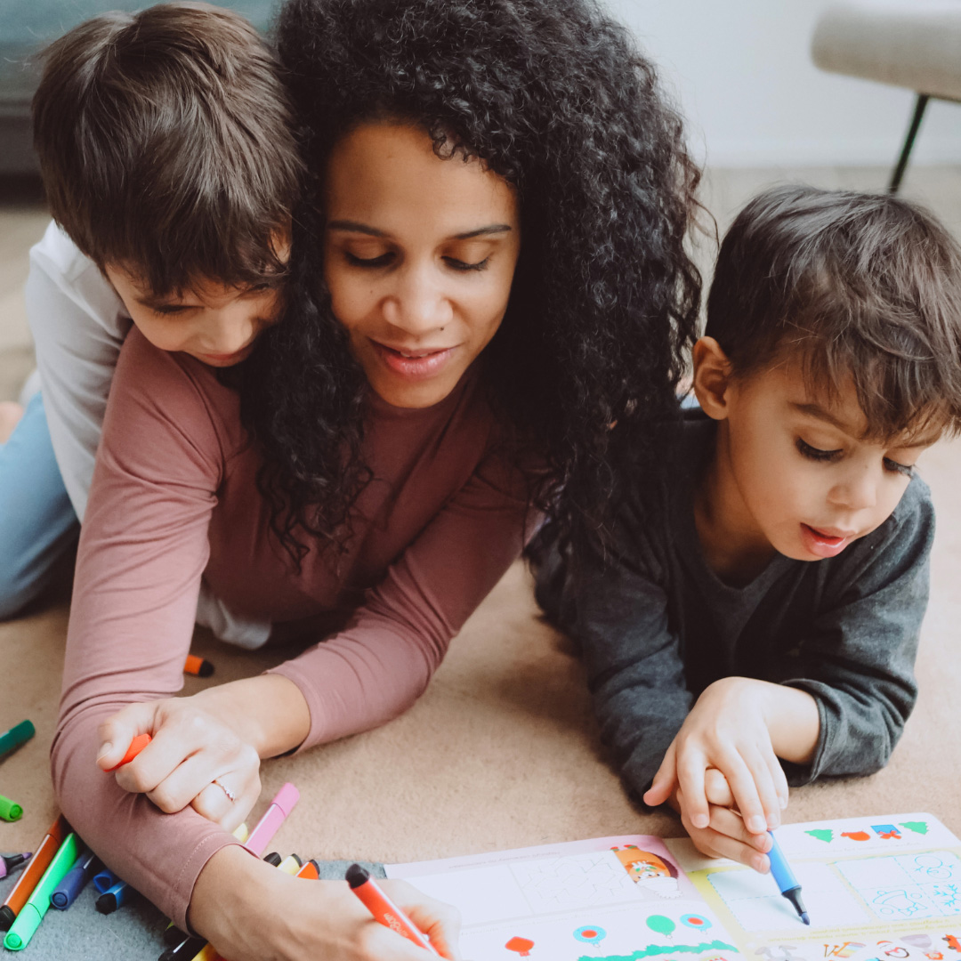 mom and kids spending time together coloring