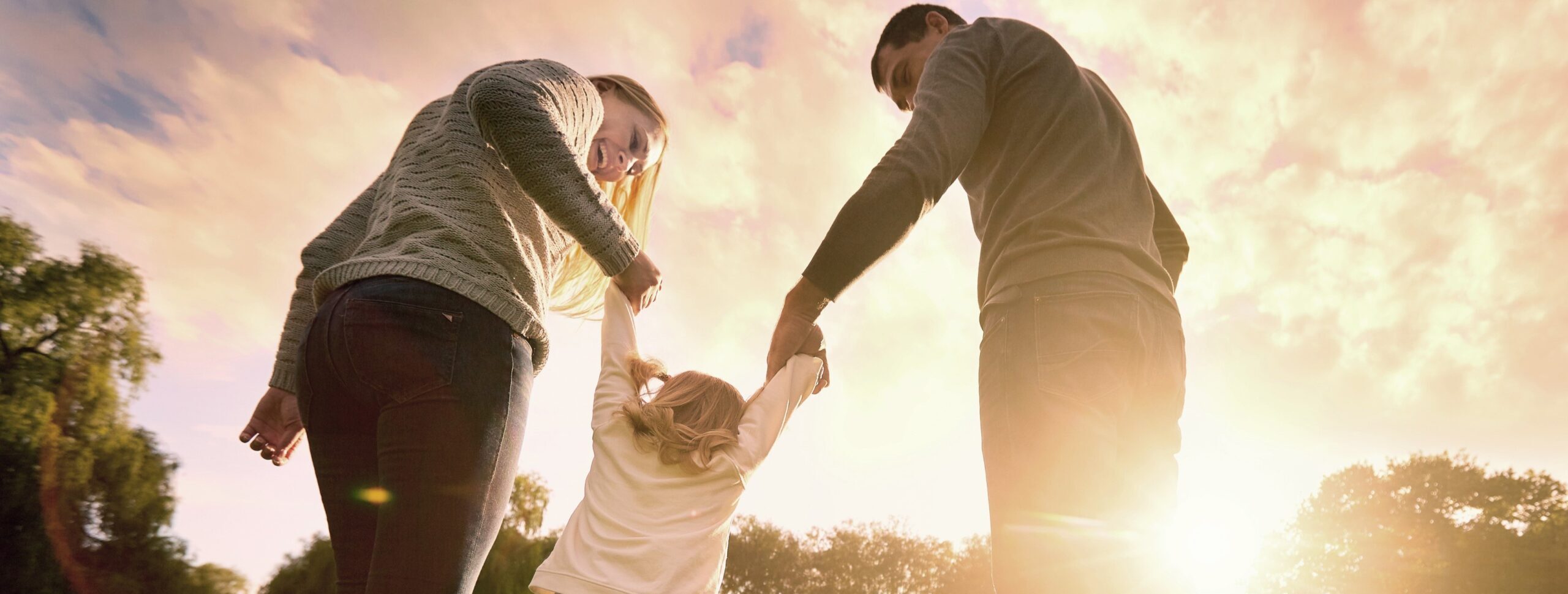 family outside holding hands
