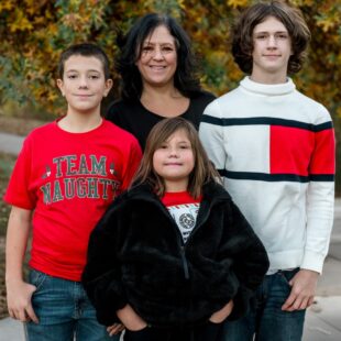 Chelle, back middle, surrounded by her three children