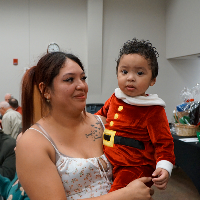 Mother and young son in a Santa outfit