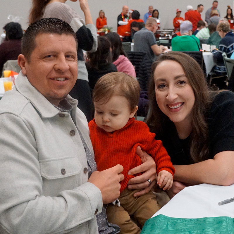 Father and mother pose with their young son