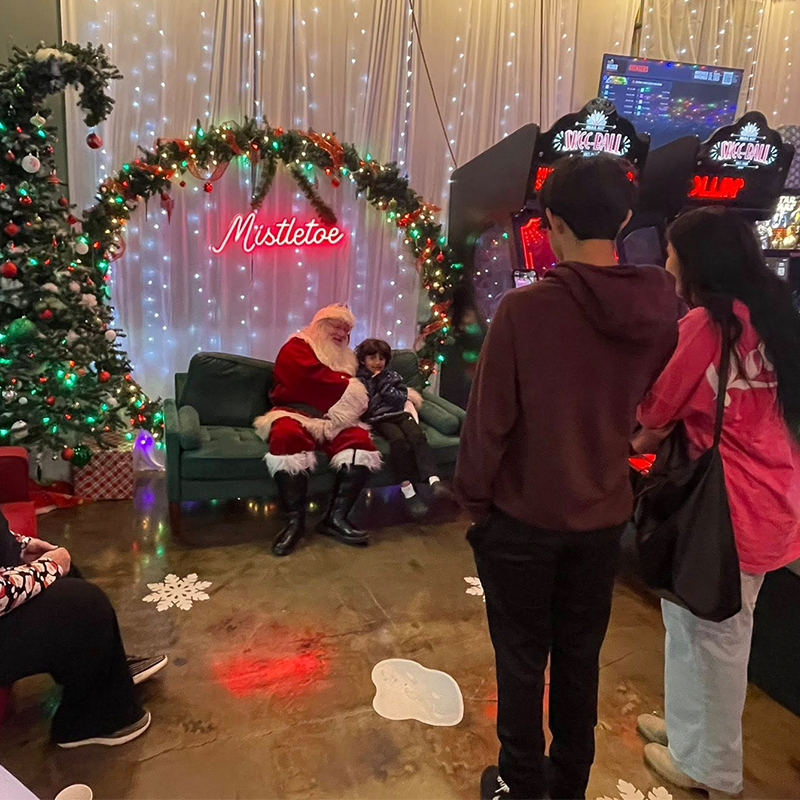 Families taking pictures with Santa at Red Stocking Breakfast Topeka 2025
