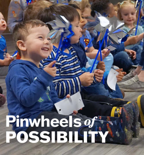 smiling boy with pinwheel